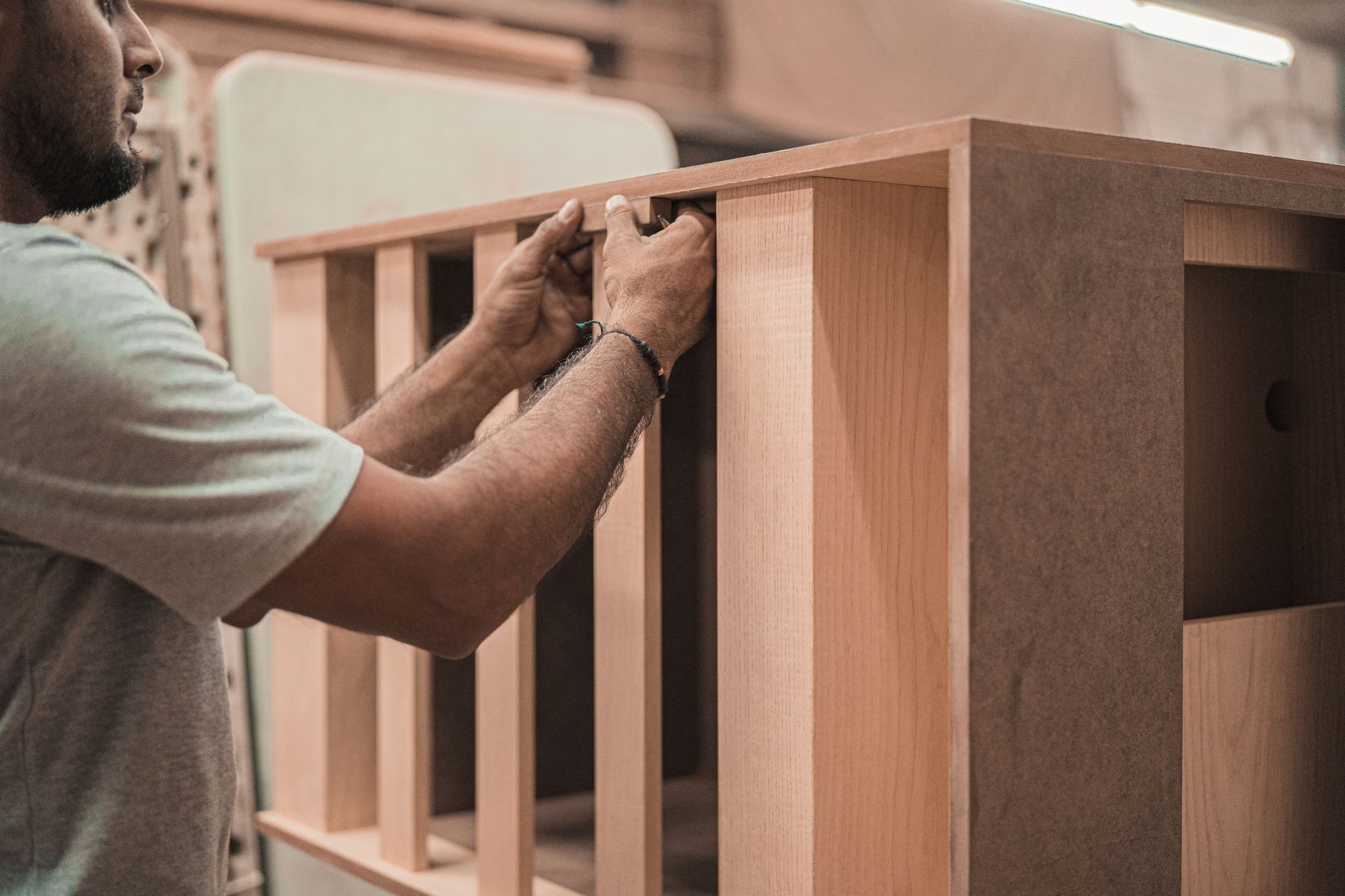 A joiner fitting hand-made timber cabinetry